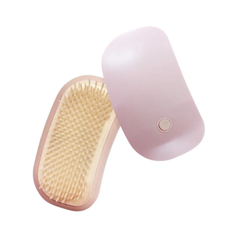 Fuigarry pink handheld electric pet grooming brush with soft TPE teeth on a white background