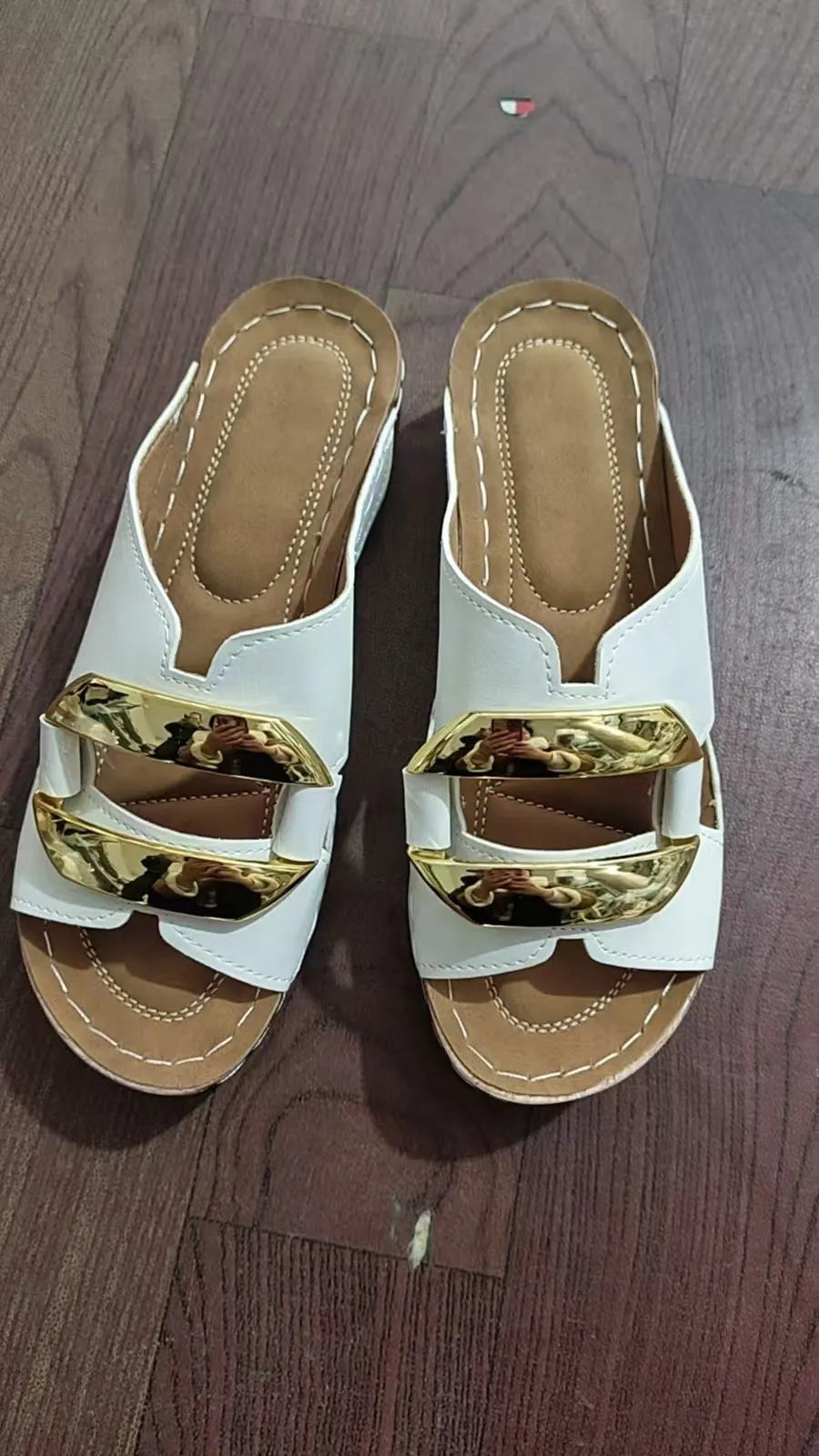 Roman-style platform flip-flop sandals in black, white, khaki, and sea blue on a rubber sole.