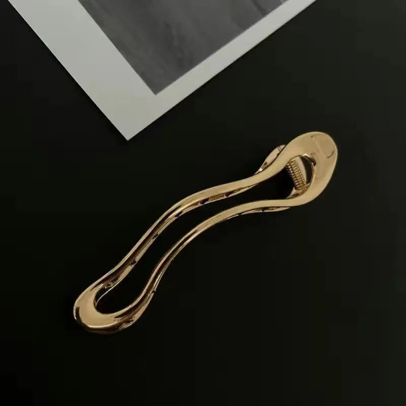 Women's zinc alloy hair barrettes in gold and silver with square, arc, and triangle shapes