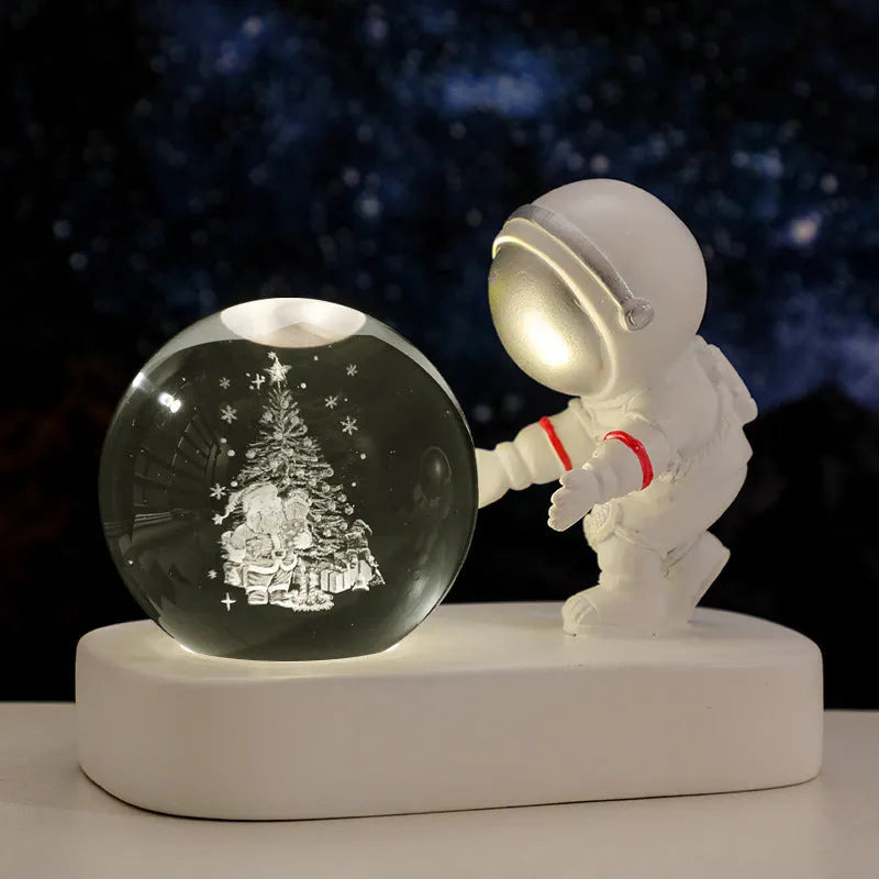 Glowing astronaut crystal ball night light with 6cm diameter and USB cable on wooden surface