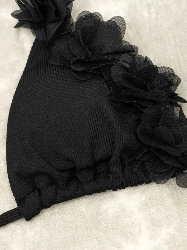 Black two-piece swimwear set with gathered top design and matching shorts
