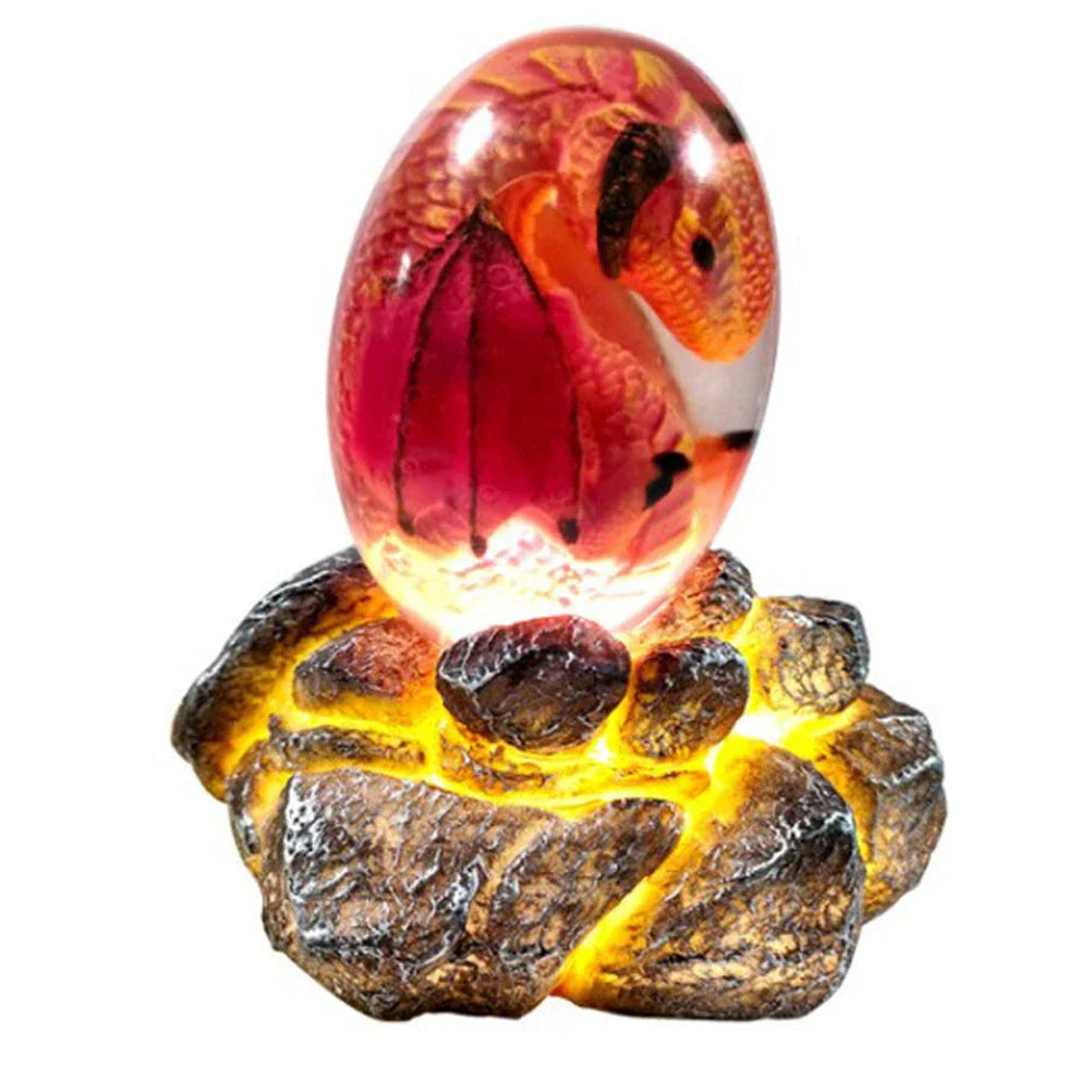 A lifelike resin dragon egg ornament with a crystal-clear, transparent design, sitting on a glowing lava-style base.