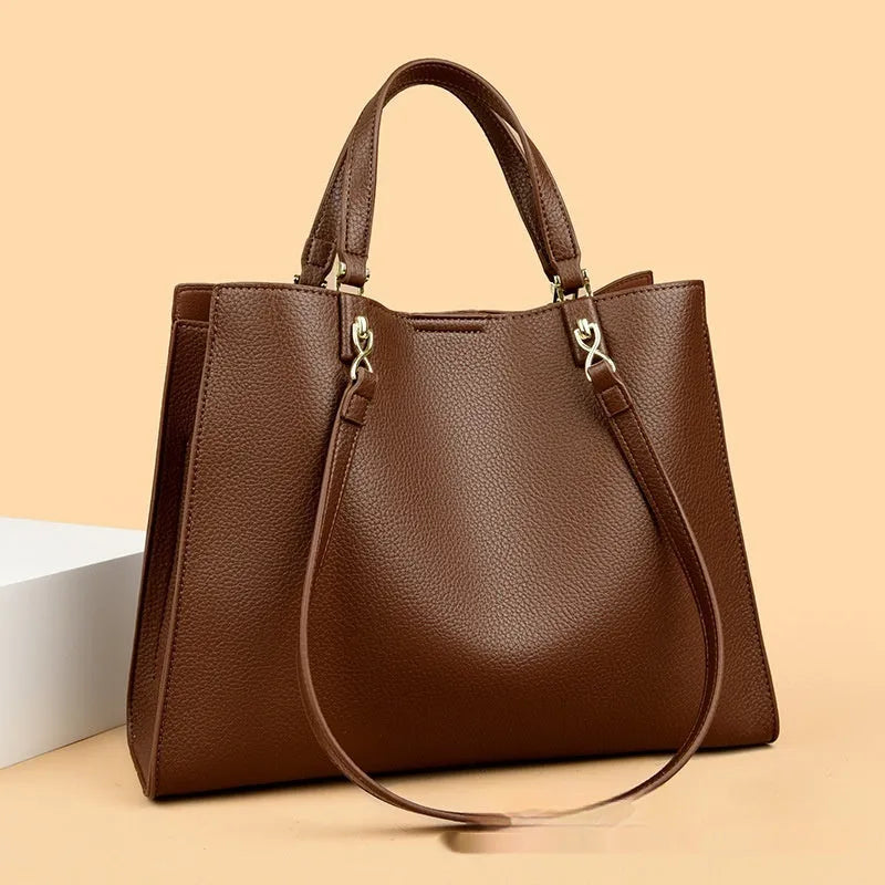 Women's messenger tote bag in horizontal square shape with crossbody strap and internal compartments