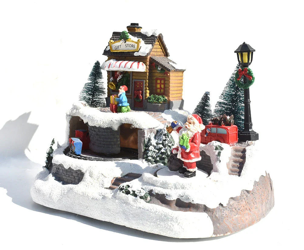 Illuminated Christmas village house with rotating Santa, Snowman, and Christmas tree decorations and playing holiday music
