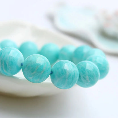 Amazonite gemstone bracelet with green-blue beads on a wrist