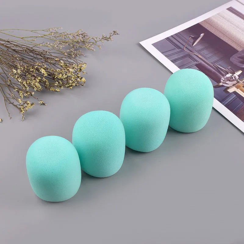 Four foam microphone wind shields in different colours for handheld stage microphones