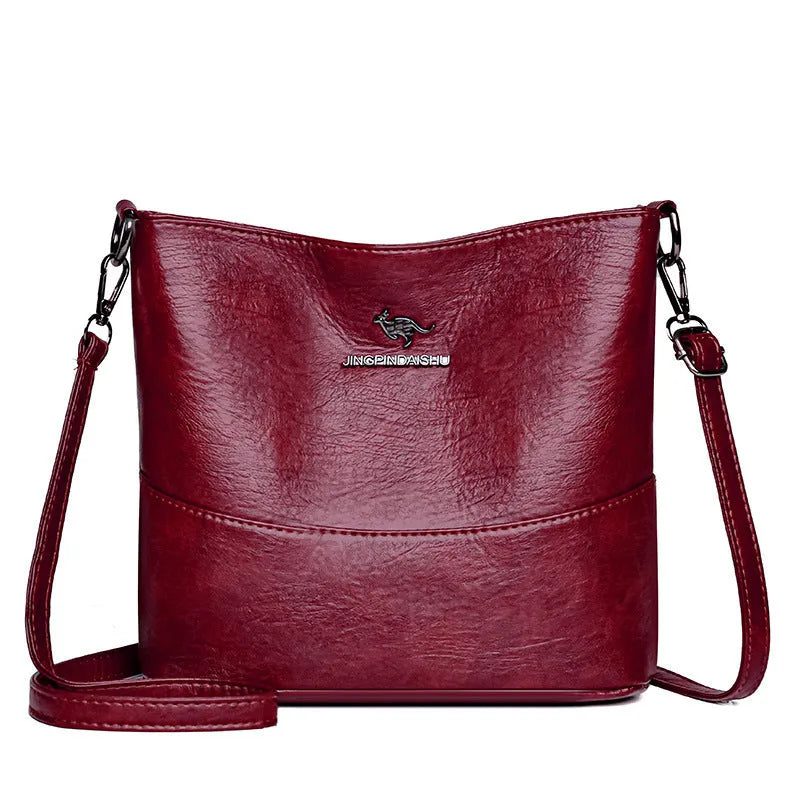 Women's soft leather bucket shoulder bag in black, wine red, or ginger yellow with large capacity and minimalist design