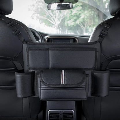 Black leather car seat gap storage bag hanging from armrest with tissue box, showing textured grain detail.