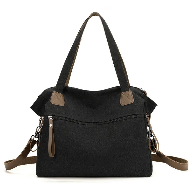 Large grey retro-style canvas shoulder bag with a horizontal square shape and multiple internal pockets.