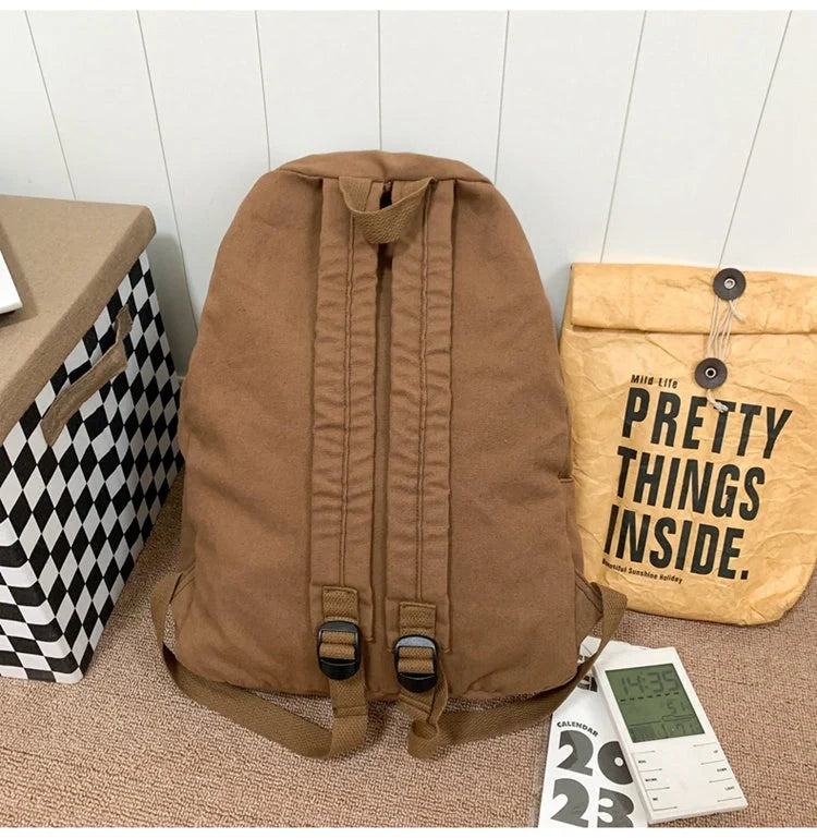 Brown canvas backpack with geometric patterns, ideal for female college students