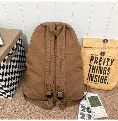 Brown canvas backpack with geometric patterns, ideal for female college students