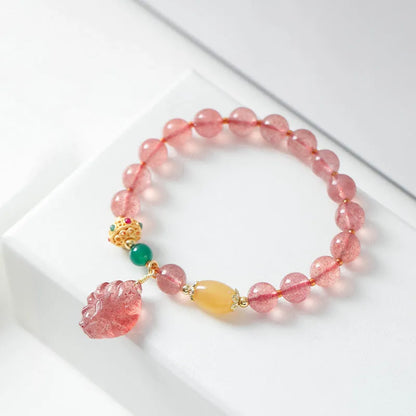 Women's strawberry quartz crystal beaded bracelet with Nine Tail Fox design on wrist