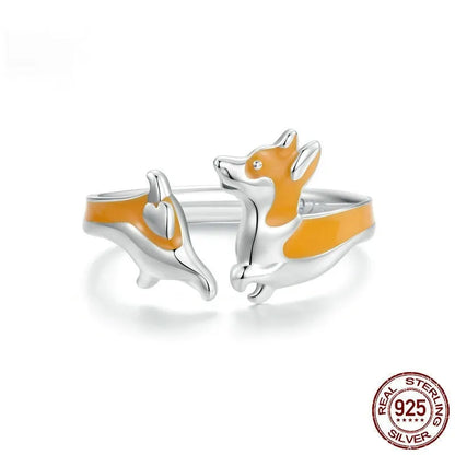 Close-up of an adjustable silver-toned ring with a detailed cartoon corgi dog design.