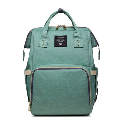 Stylish maternity diaper bag in various colors, featuring a paper bag design, separate bottle compartment, and discreet breastfeeding button.