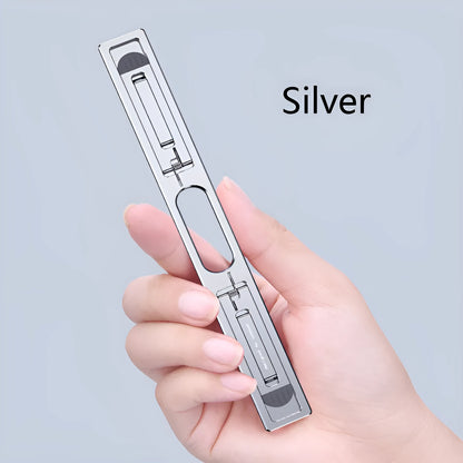 Silver aluminium laptop stand with an adjustable base on a wooden desk.