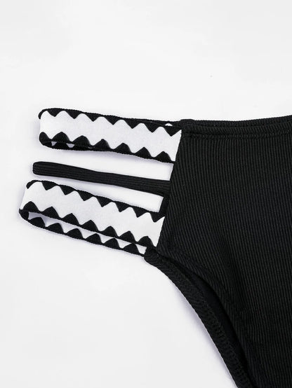 Black women's hollowed-out split swimsuit bikini set on a model.