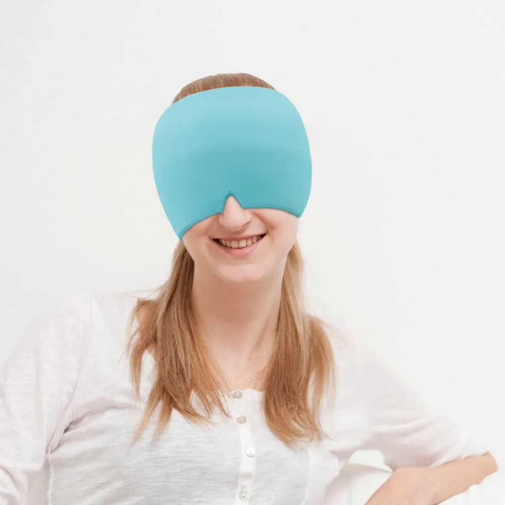 Black elastic cloth gel cold compress eye mask for headache relief on a grey background.