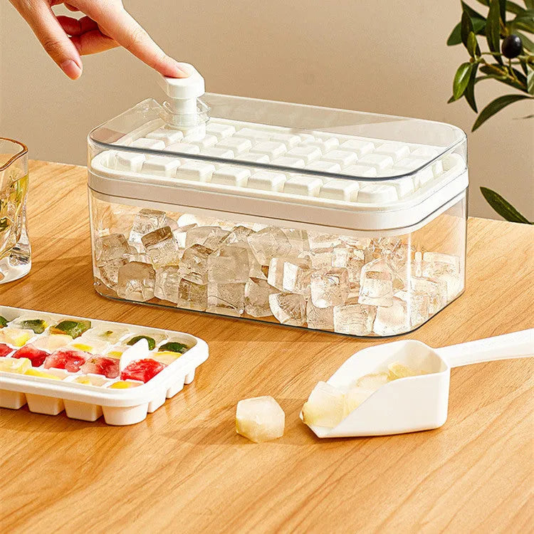 Green one-button press ice mould box with storage lid and ice shovel on kitchen counter