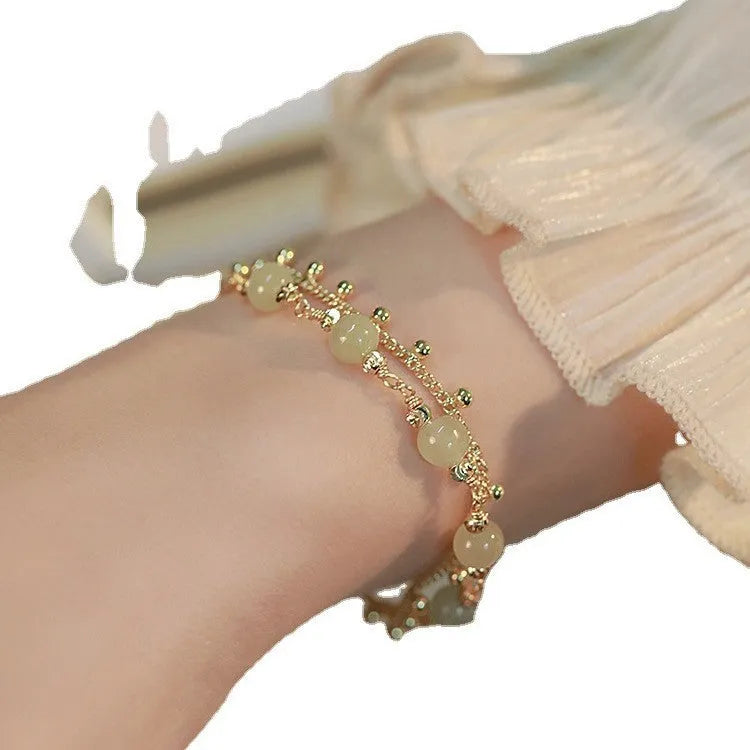 Handmade natural Hetian Jade women's bracelet in a classic beaded style.