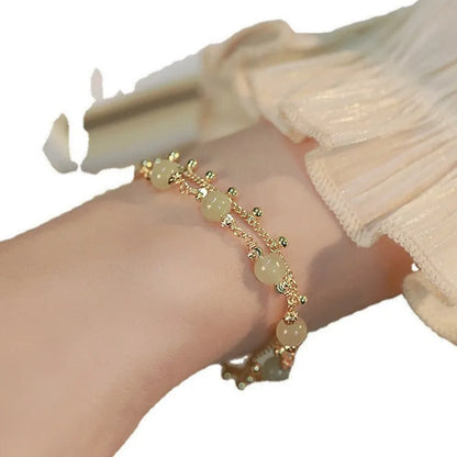 Handmade natural Hetian Jade women's bracelet in a classic beaded style.