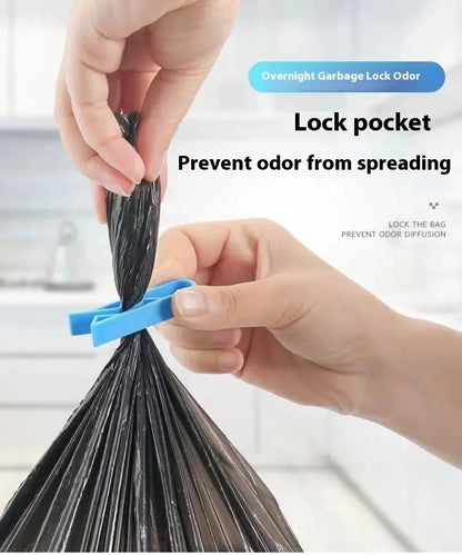 A white polypropylene plastic clip for holding a rubbish bag onto the rim of a bin.