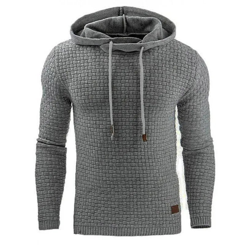 A man wearing a cotton-polyester blend hoodie available in nine colours including black, navy, and red.