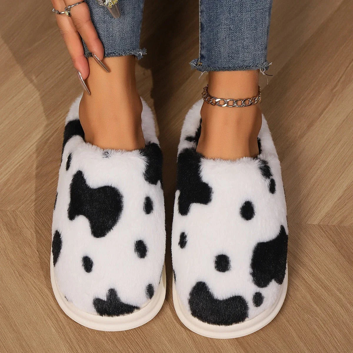 Cozy cow print plush slippers with soft, cushioned soles and non-slip outsoles for indoor comfort and warmth