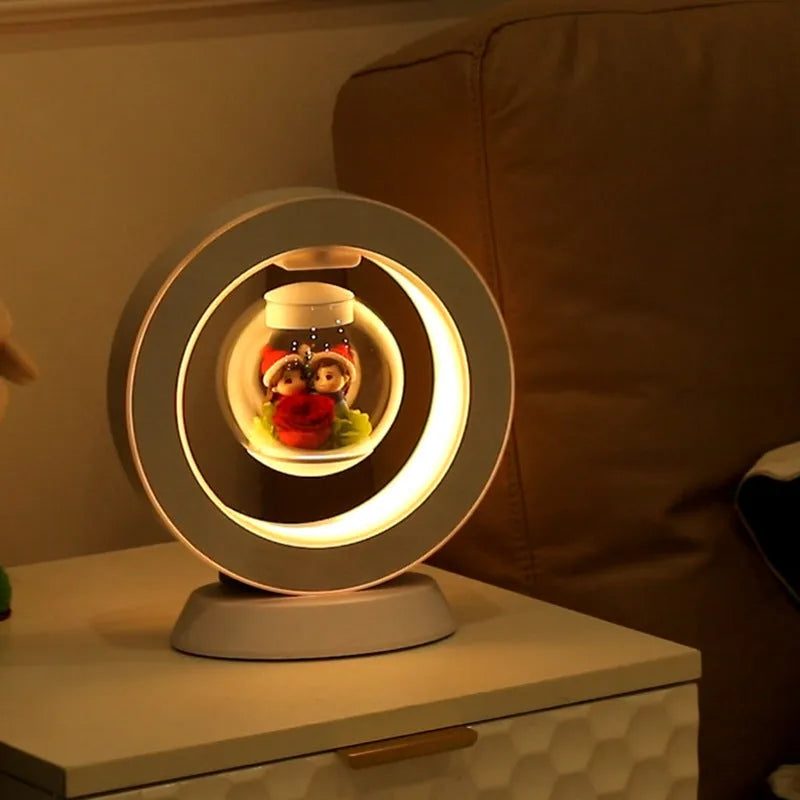 Pink rose eternal flower floating in magnetic levitation LED night light with triangular base and touch control