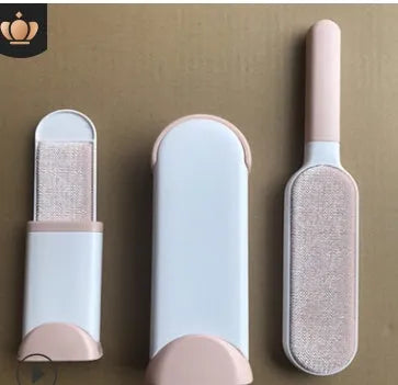 Blue reusable pet hair removal brush with double-sided head next to its self-cleaning base.