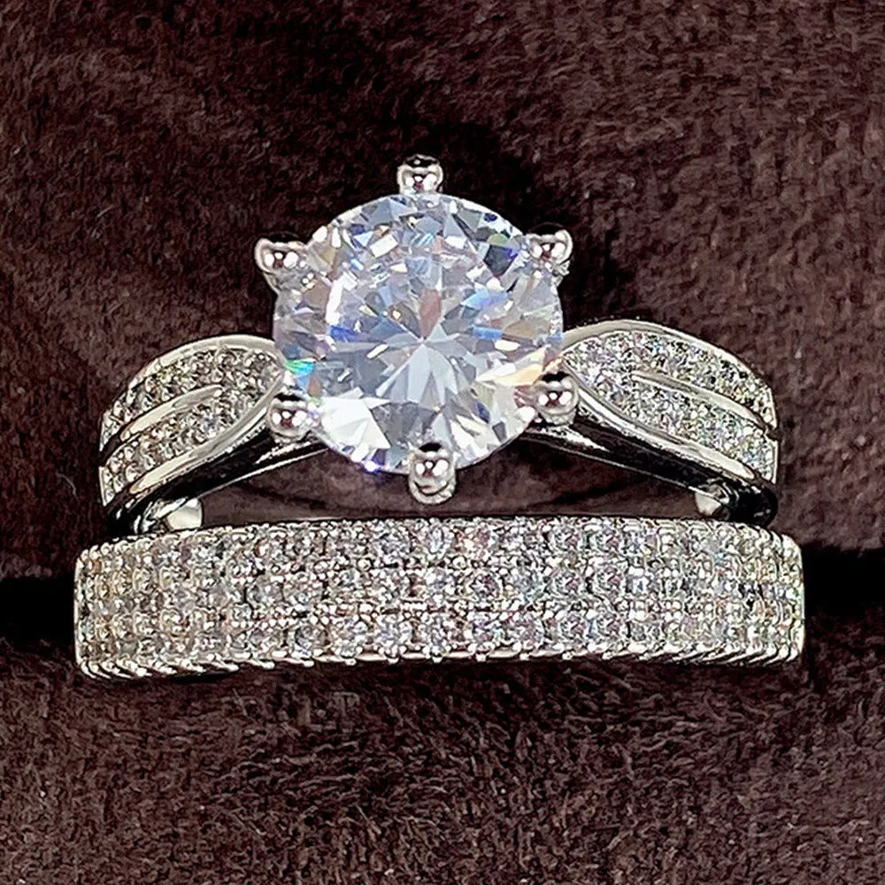 White gold-coloured geometric wedding ring with round elements on a finger