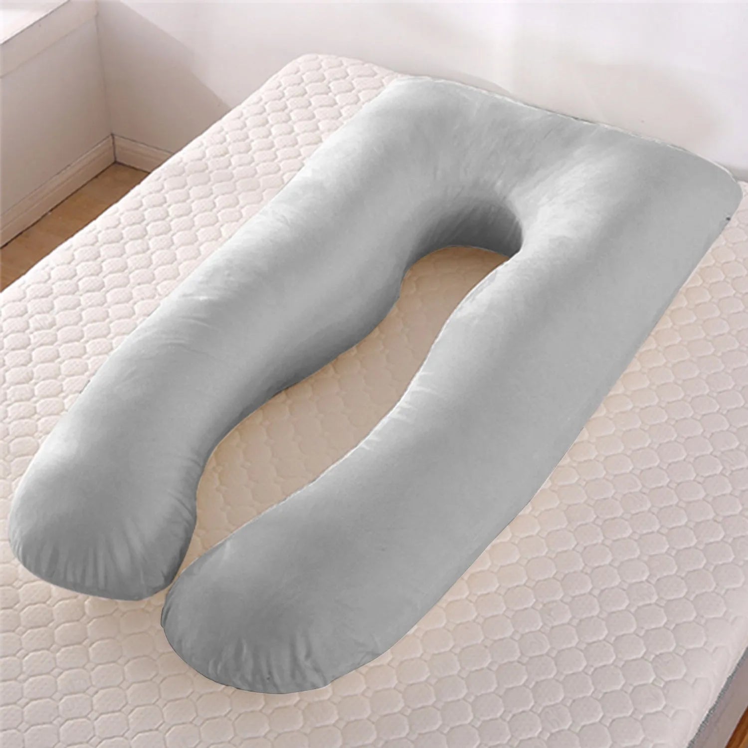 Light blue U-shaped ice silk maternity pillow for pregnancy support on a bed