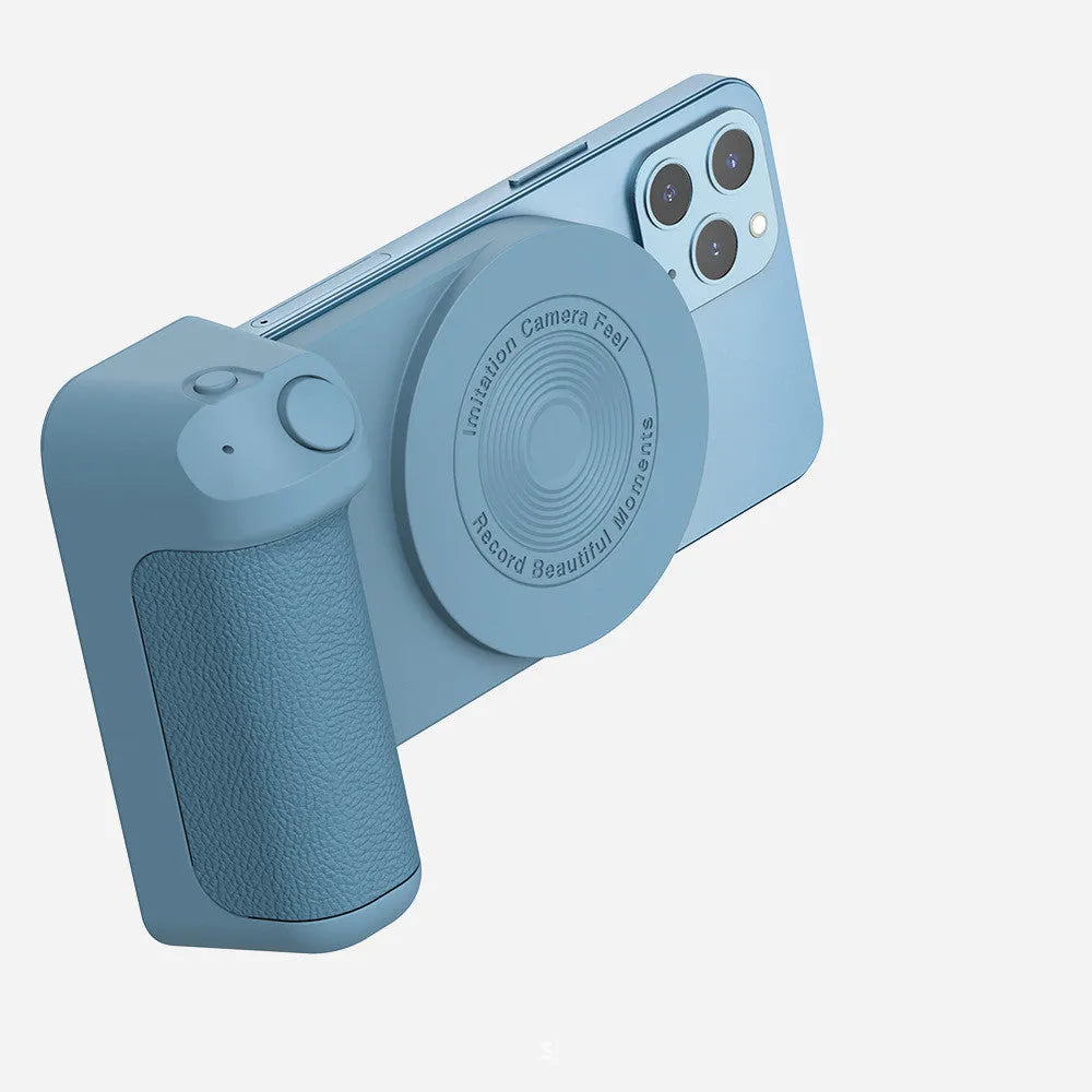 Black magnetic phone camera grip with rotatable bracket and ergonomic PU leather handle on a table.