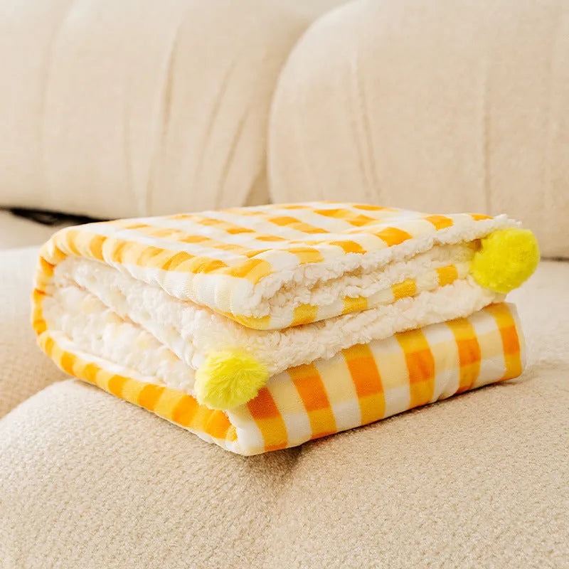 A blue coral fleece pet blanket laid flat, showing its soft texture and rectangular shape as a dog or cat bed mat.