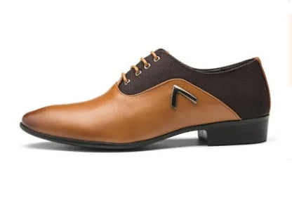 Men's black Oxford dress shoes with a rubber sole on a wooden floor.