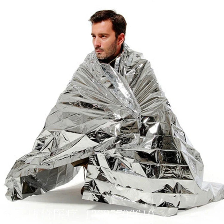 Portable double-sided silver emergency thermal blanket for outdoor adventures and survival situations