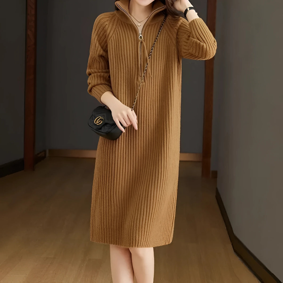 Beige half-zip woolen skirt with long sleeves, a stand collar, and a loose, straight midi silhouette.