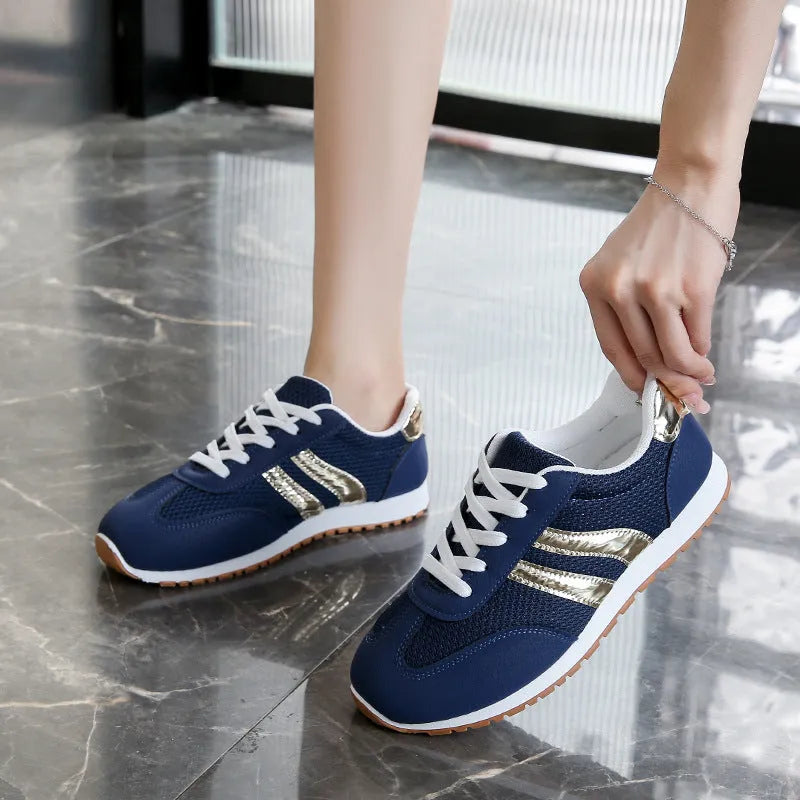 Blue women's casual sports shoes with cross shoulder straps and a round toe, featuring a flat heel and lace-up front.