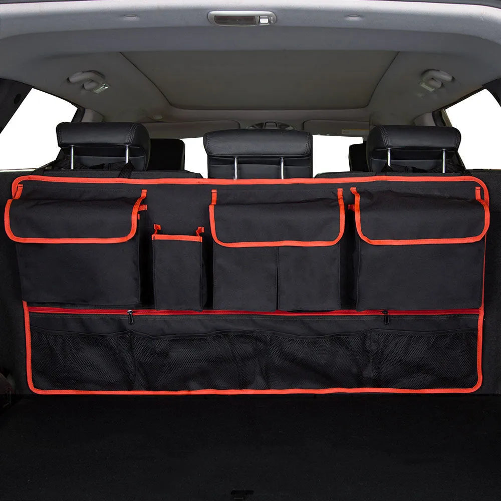 Black car hanging storage bag made of waterproof Oxford cloth with a handle, shown hanging in a vehicle boot.