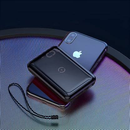 Small square black wireless charging power bank with LED display showing battery percentage.