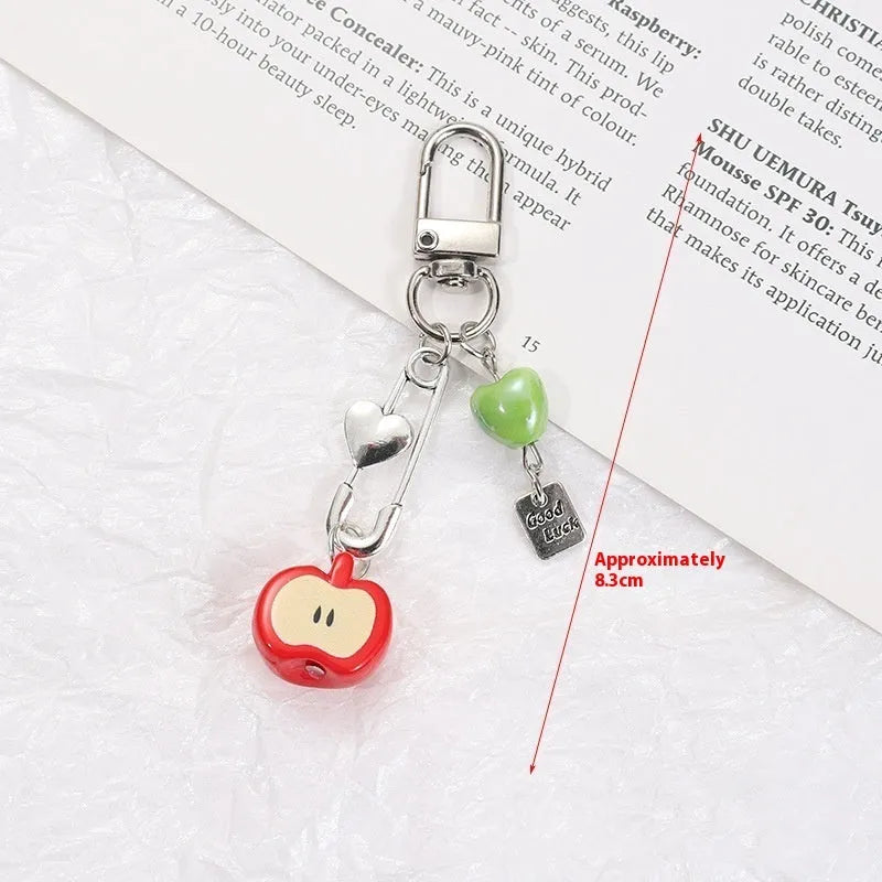 Plastic and resin fruit charm keychain with apple, strawberry designs on silver rope