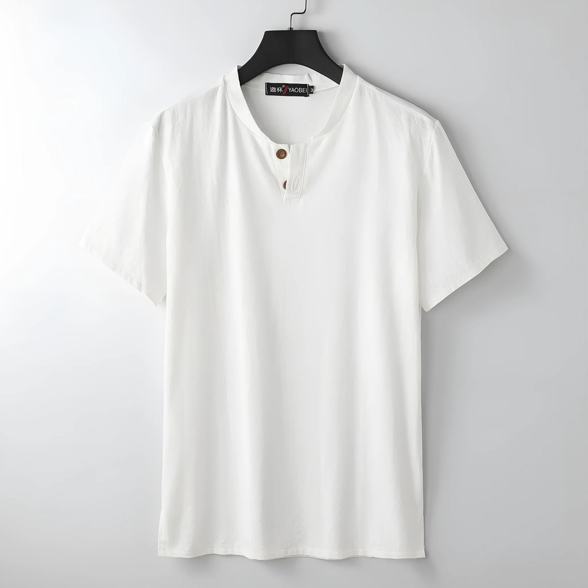 Women's loose fit apricot cotton V-neck short sleeve pullover top on a hanger.