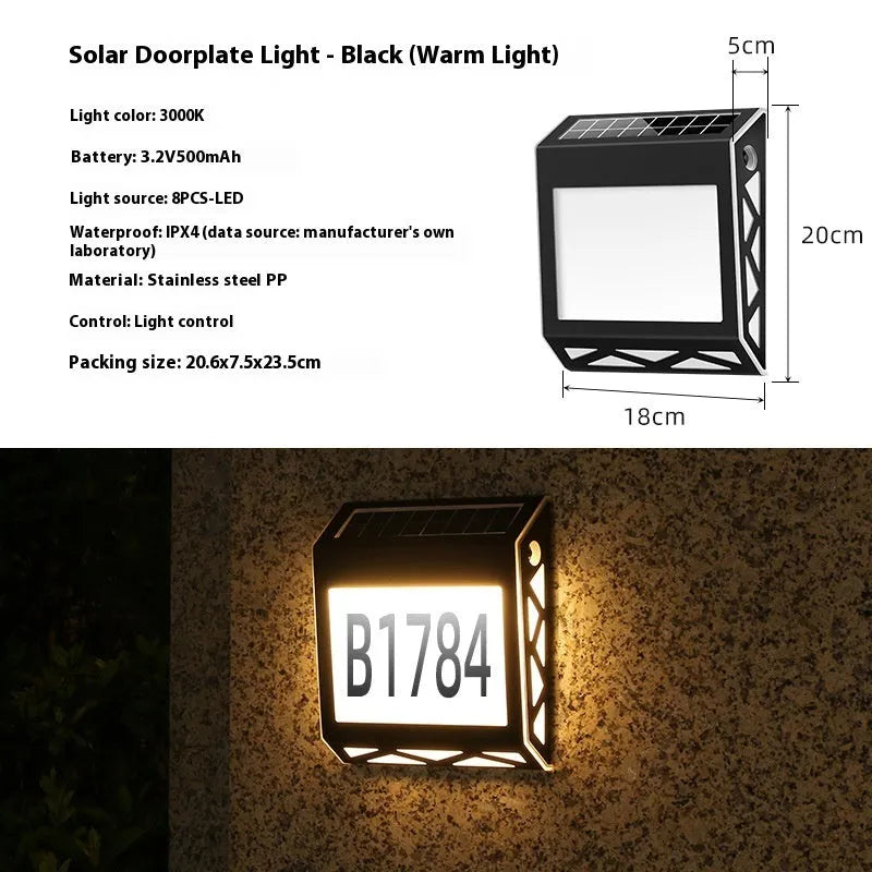 Black solar doorplate light with LED illumination showing house numbers