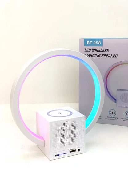 White smart speaker with wireless charging surface, LED lights, and Bluetooth connectivity