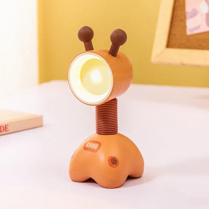 Colourful cartoon character magnetic DIY night light on a desk with adjustable head.