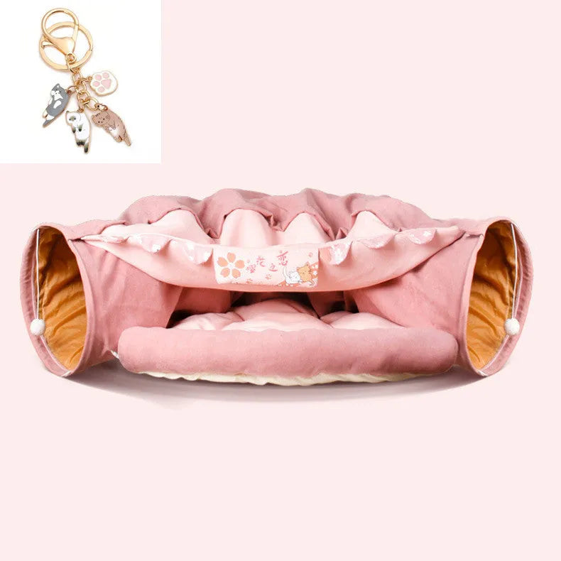 Collapsible cloth cat tunnel in pink colour, shown in both open and folded positions.