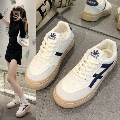 Low-top blue and brown casual lace-up shoes with round toe and flat rubber sole.