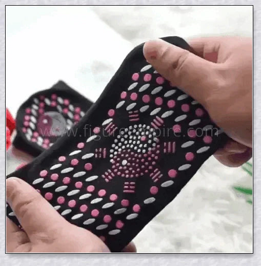 Pair of self-heating massage socks with detailed view of the acupressure-inspired soles
