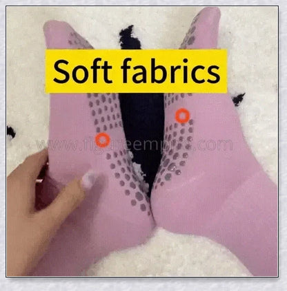 Pair of self-heating massage socks with detailed view of the acupressure-inspired soles