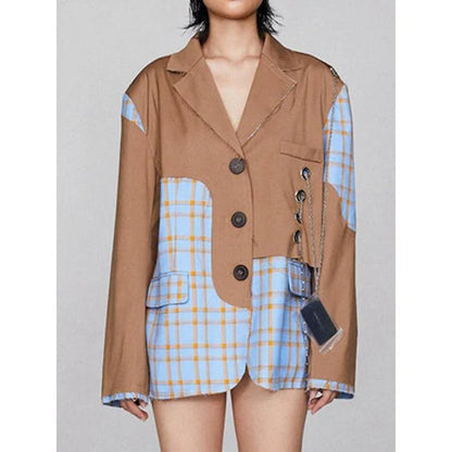 A chic women's winter blazer with a checkered pattern and chain accent, perfect for the modern British fashion enthusiast.