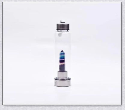 A handcrafted glass water bottle infused with natural crystals, offering a unique and sustainable hydration experience.